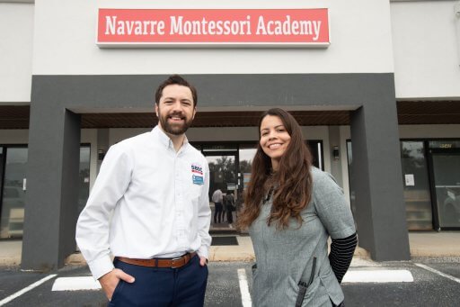 Florida SBDC at UWF Assistant Director John Emsing and client Kiani Richardson who owns and runs Navarre Montessori Academy