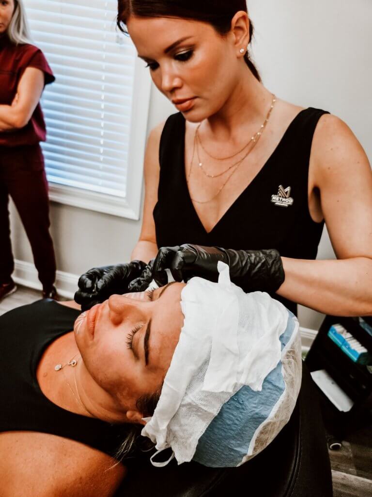 Brittany Perez, of MELA Medical Spa and Method Aesthetics Academy in Pensacola, works on a patient.