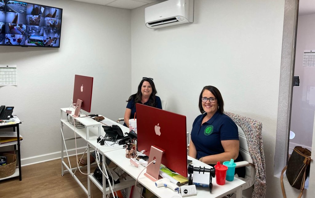 Jackson County Learning Academy, or JACOLA, founders Georgeann Adkison and Amanda Eagle smile at their desks in the center.