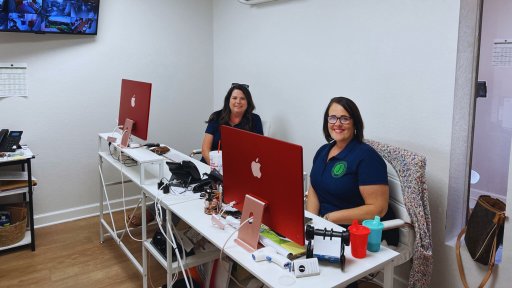 Jackson County Learning Academy, or JACOLA, founders Georgeann Adkison and Amanda Eagle smile at their desks in the center.