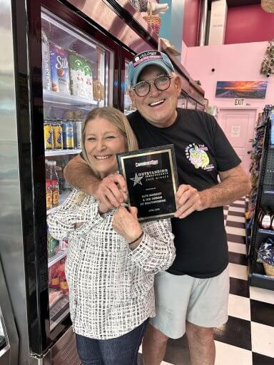 Owners Judy Moldovan and Alan Mandel pose with their award plaque at their shop.