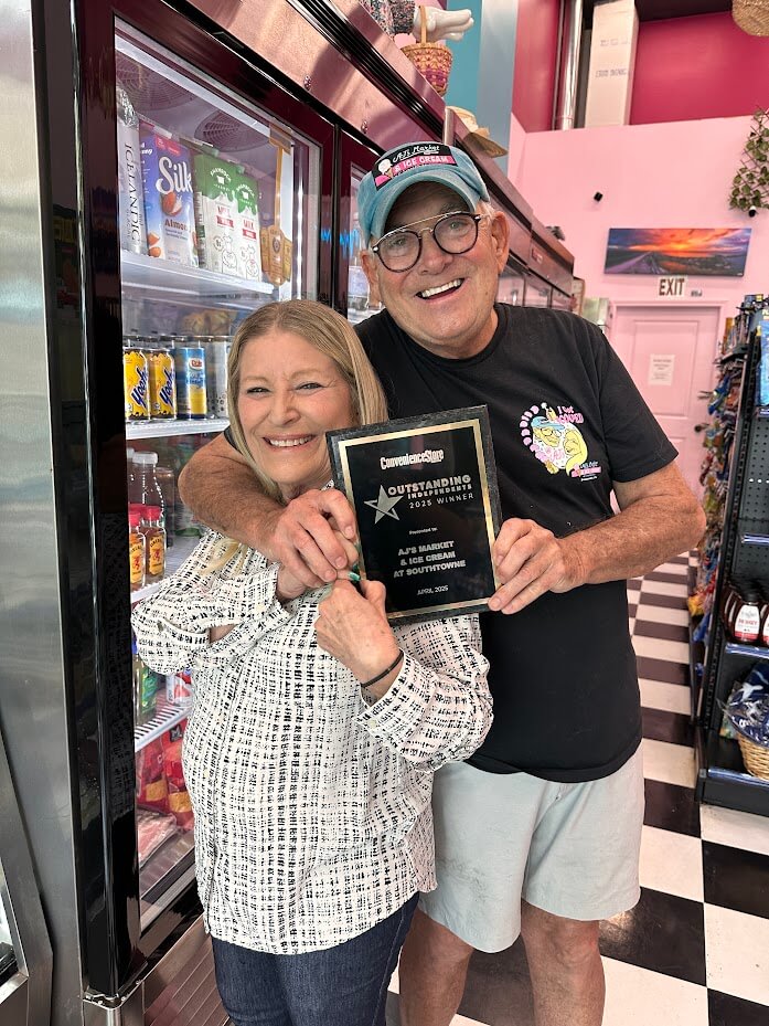Owners Judy Moldovan and Alan Mandel pose with their award plaque at their shop.