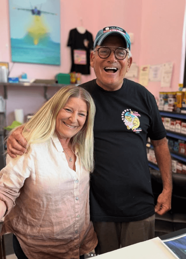 Alan Mandel poses with his arm around wife Judy Moldovan at AJ's Market.