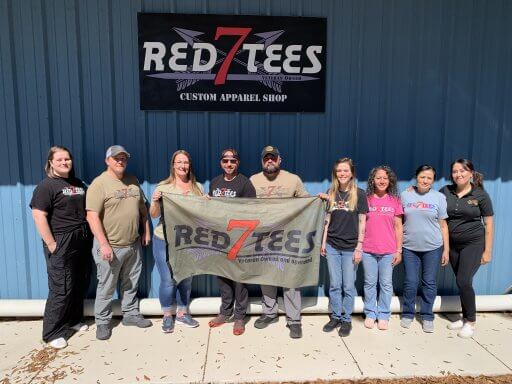 Red7Tees staff poses in front of their company building